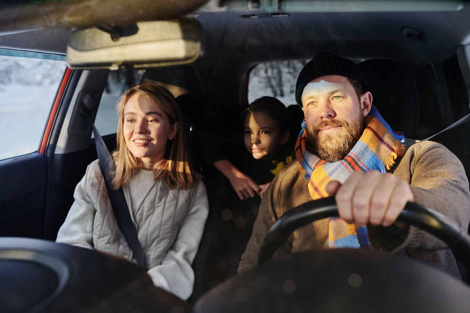 family travelling by car in winter