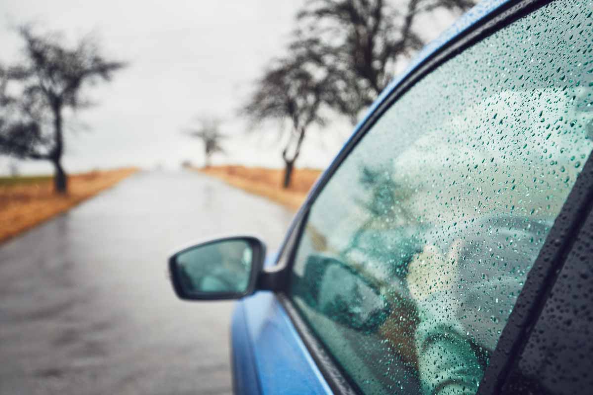 rainy day on the road man is driving car in rain